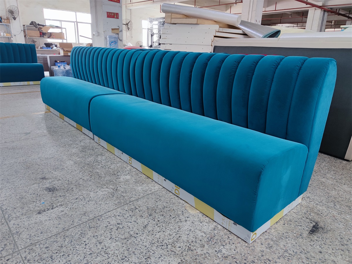 Modern blue velvet restaurant booth with channel tufted backrest