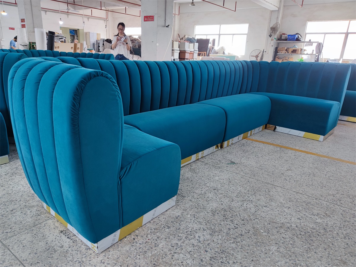 U-shaped velvet bar lounge booth with vertical channel backrest in factory setting