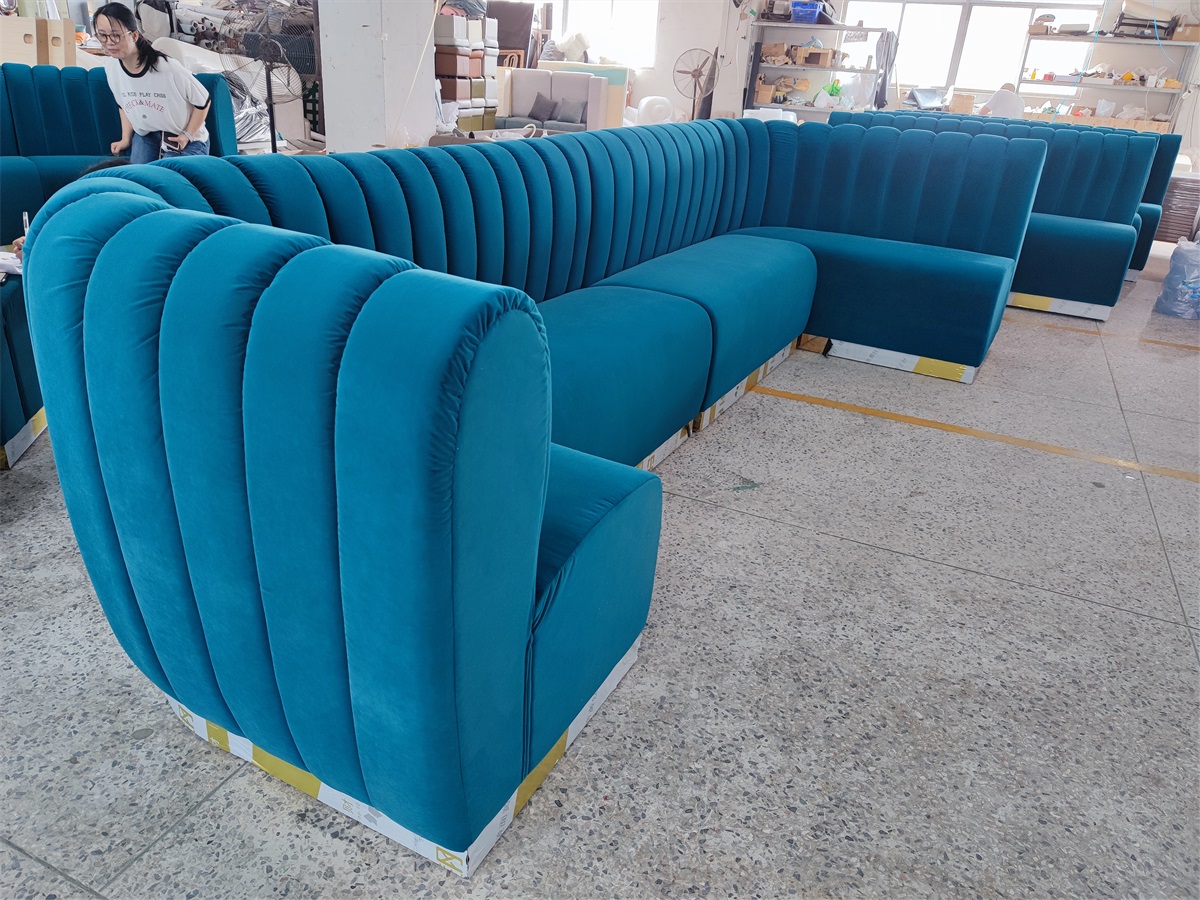 Custom modular bar banquette seating with plush blue velvet upholstery