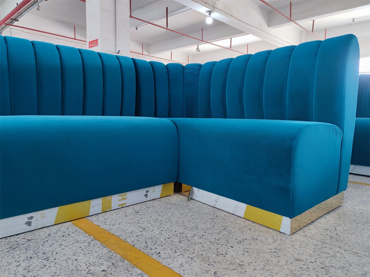 Commercial bar booth with gold metal base and curved end design