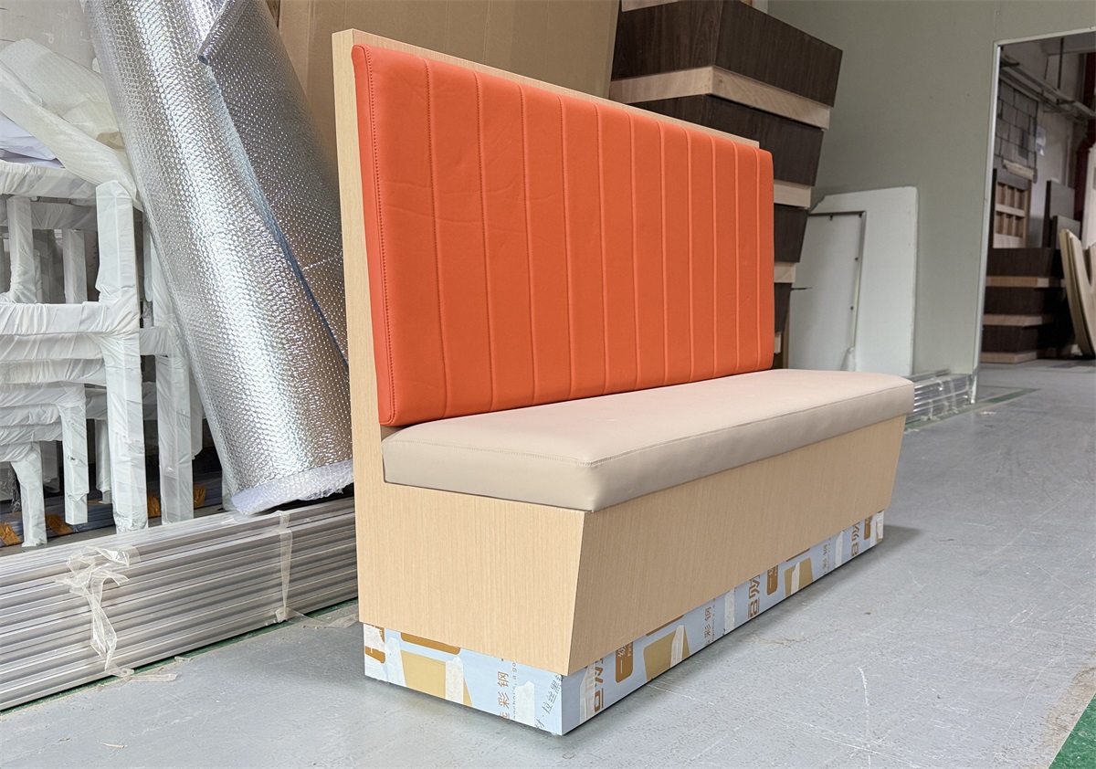 Durable vinyl upholstered restaurant booth in vibrant orange and neutral beige colors