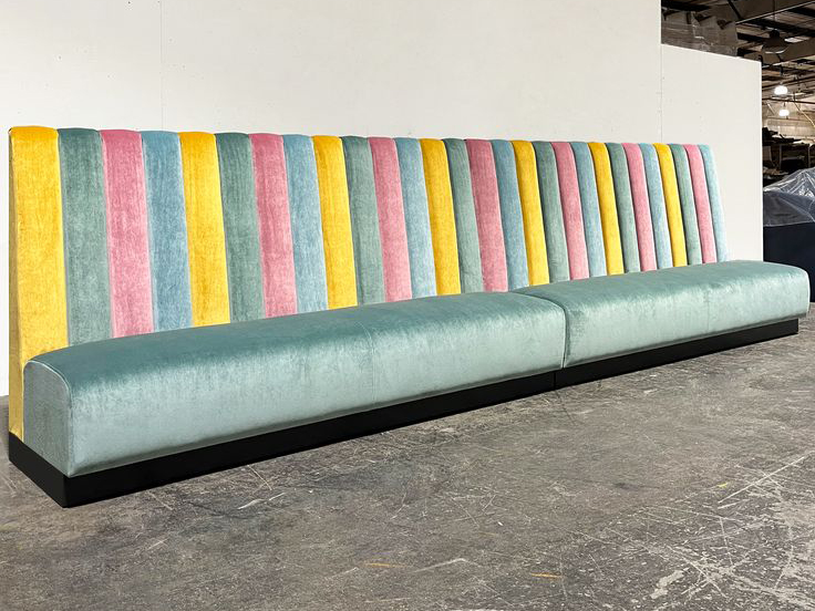 Colorful retro velvet restaurant booth with striped backrest
