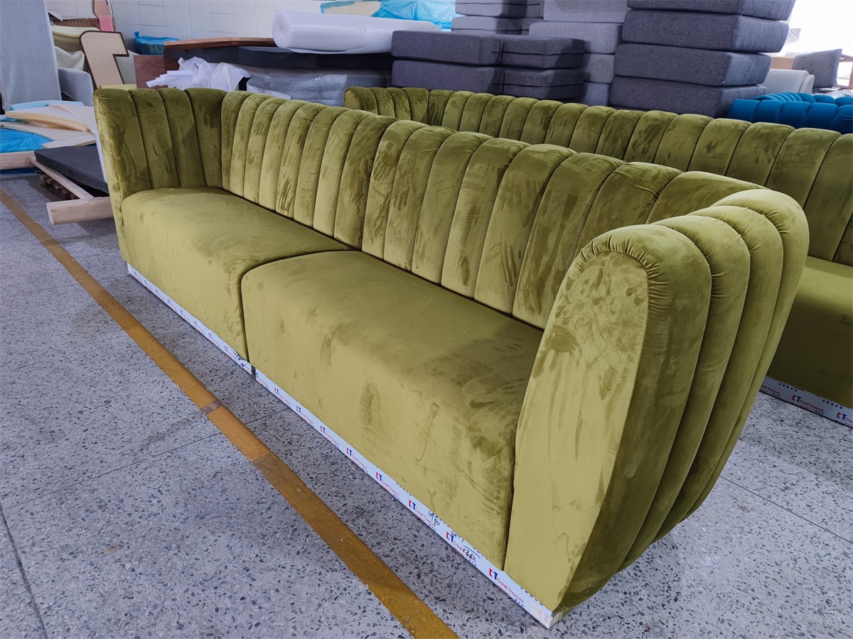 Olive green velvet banquette sofa with channel tufted backrest