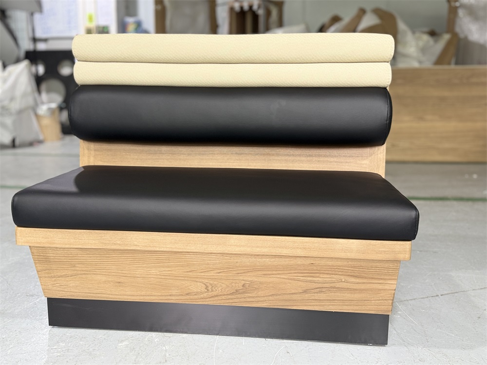 Modern restaurant booth with black leather seat and beige fabric backrest
