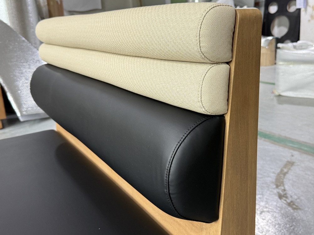 Close-up of beige fabric roll and black faux leath